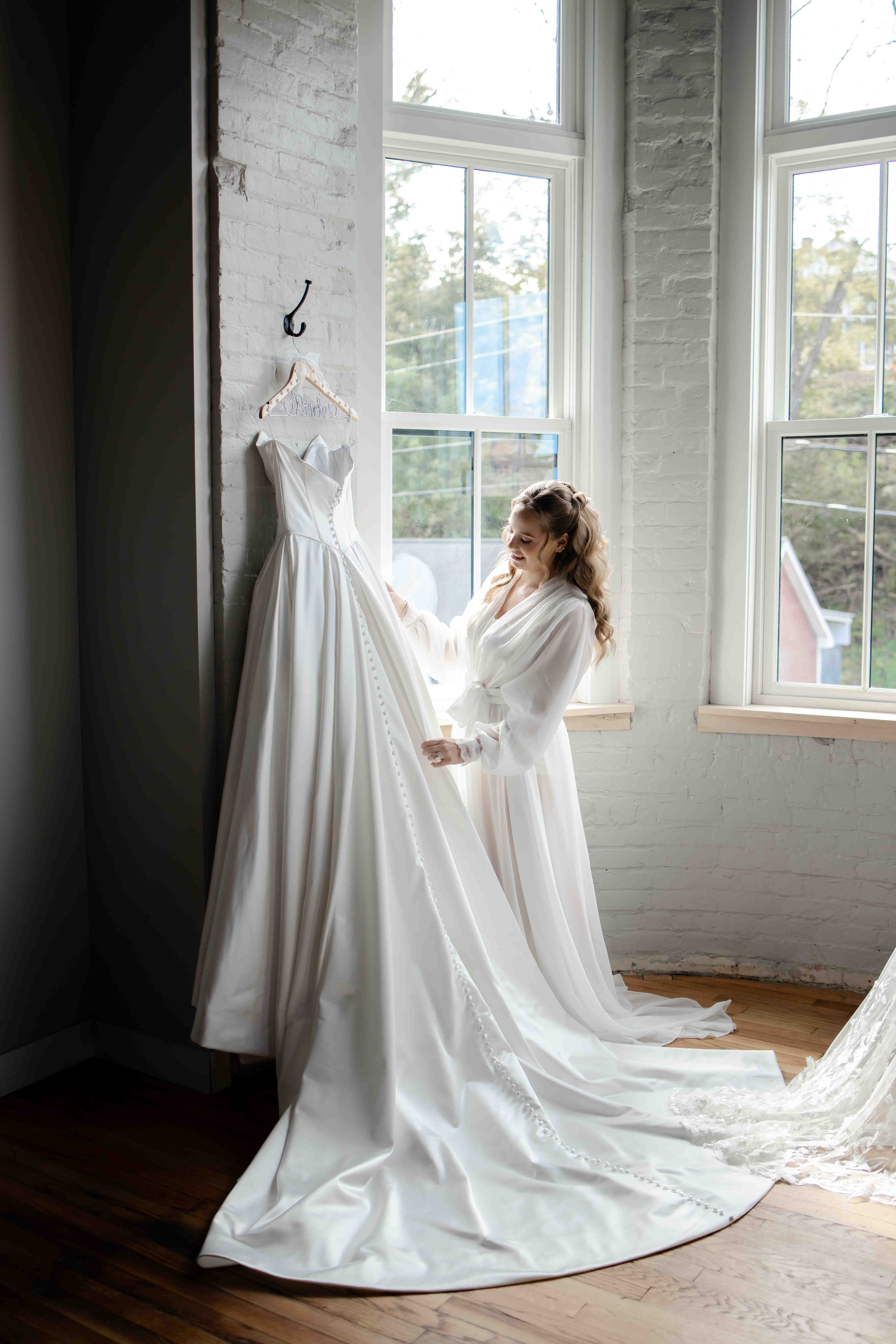 Candid photo of a bride laughing with her bridesmaids